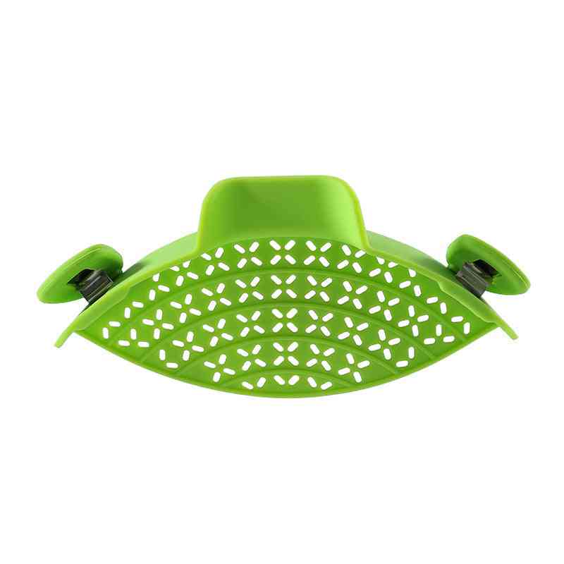 Green silicone pot side drain with a curved perforated design and secure clips for easy and spill-proof pouring.