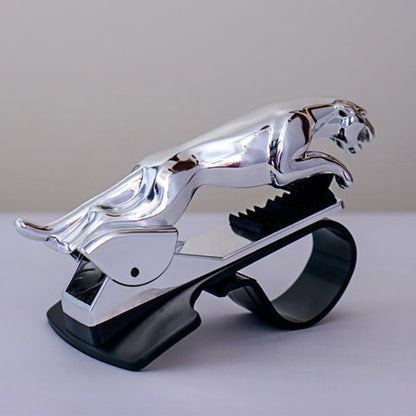 Chrome silver leopard car dashboard phone holder with a firm grip, combining elegance and functionality for hands-free phone use while driving.