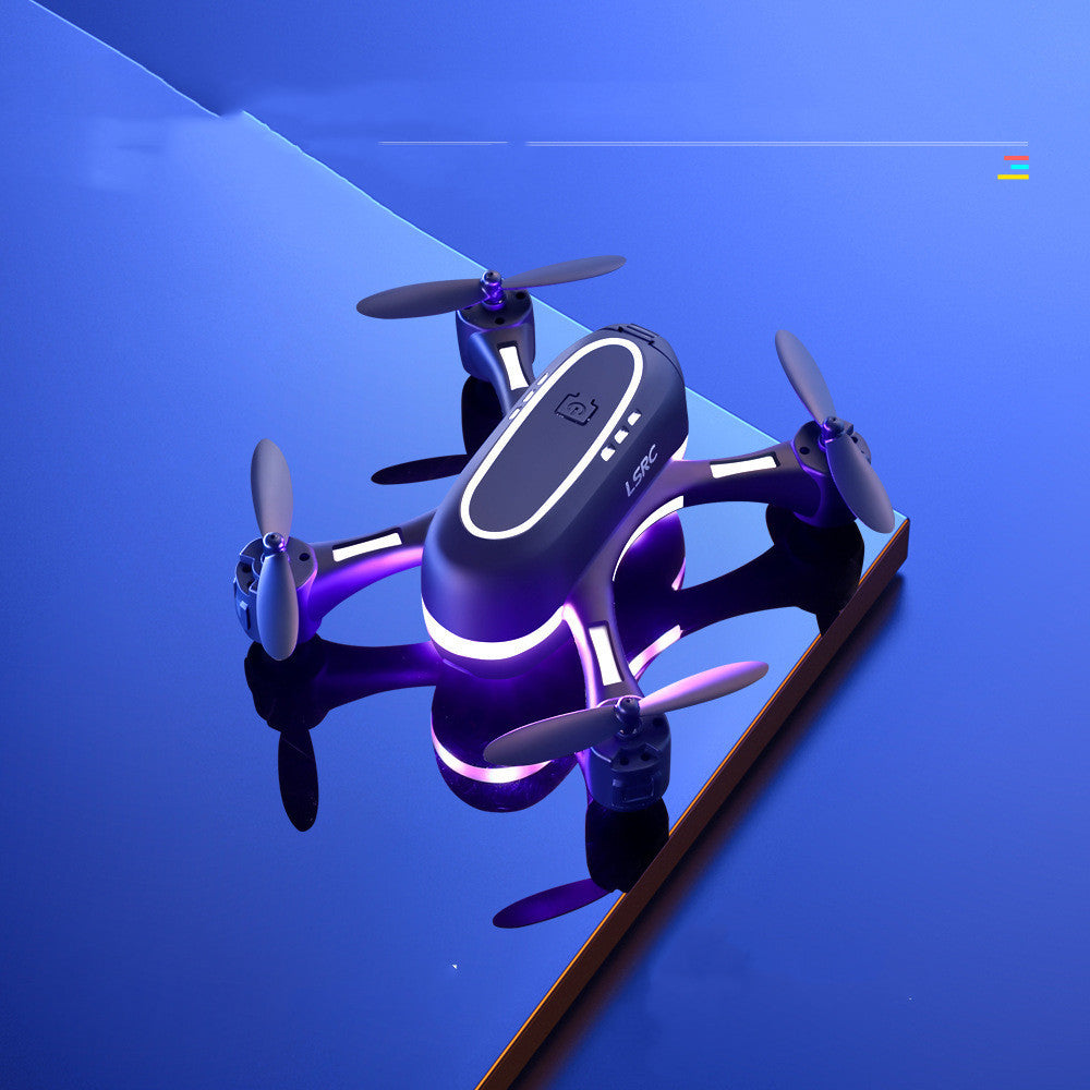 Mini remote control airplane with gradient LED lights hovering over a reflective blue surface. Compact design with four propellers for stable flight.