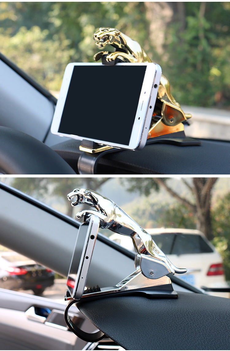 Gold leopard car dashboard phone holder with a 360° mount, securely gripping a smartphone for hands-free navigation while driving.