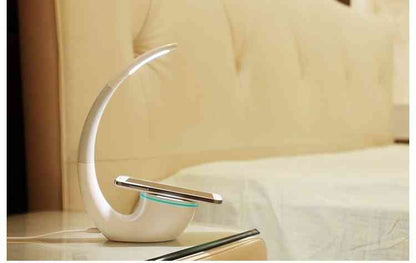 Modern Phantom wireless charger lamp placed on a bedside table, offering adjustable lighting and QI wireless charging for smartphones.