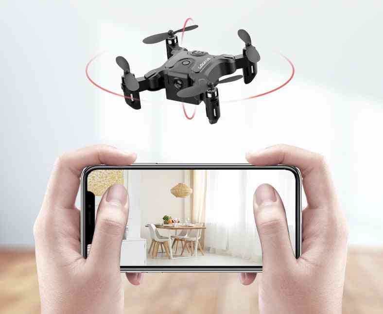 Mini folding drone in flight, streaming real-time HD video to a smartphone screen.