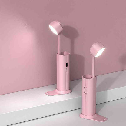 Pink multifunctional table lamp with an adjustable LED head and USB charging. Stylish and practical for bedside or workspace lighting.