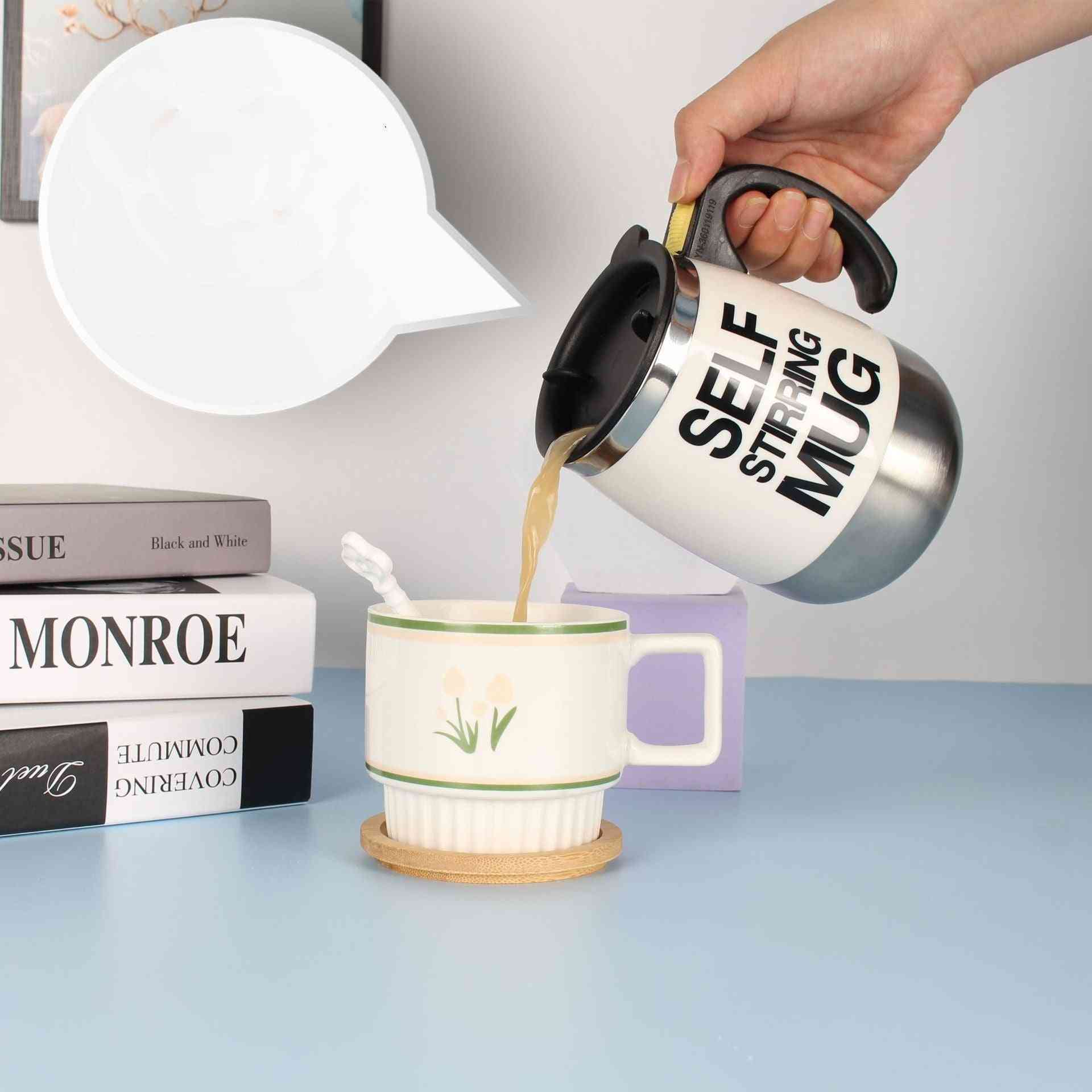 Self-stirring stainless steel electric coffee mug in use, pouring coffee into a ceramic cup, ideal for home or office convenience.