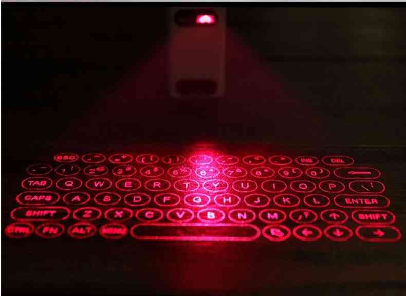 Close-up of the LEING FST Virtual Laser Keyboard Bluetooth Projector projecting a red laser keyboard on a dark surface.