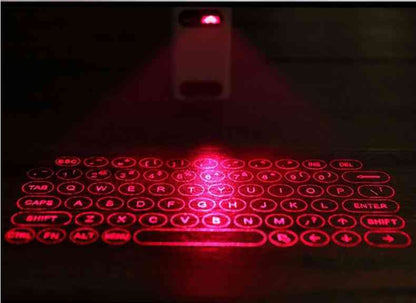 Close-up of the LEING FST Virtual Laser Keyboard Bluetooth Projector projecting a red laser keyboard on a dark surface.