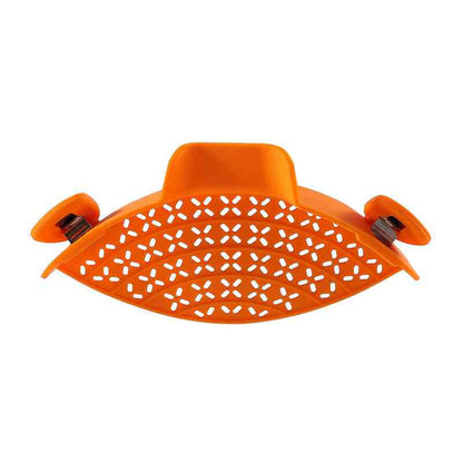 Orange silicone pot side drain with perforated design and secure clips, ideal for mess-free liquid straining.